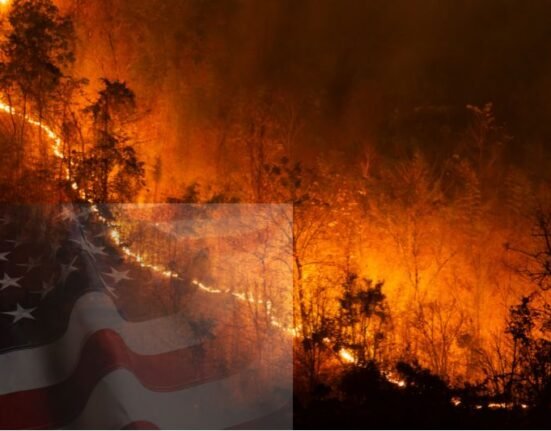 Massive wildfire consuming a forest in the American West with U.S. flag overlay, symbolizing national wildfire crisis