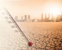 Cracked ground and thermometer illustrating surviving a heatwave in an urban area